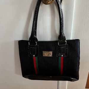 Elegant Black Handbag with Red and Green Stripes
Not a real  Gucci pocketbook